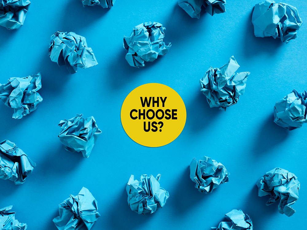 Why choose us message with crumpled blue paper balls on blue background. Reasons or benefits to choose a company service or product in business.